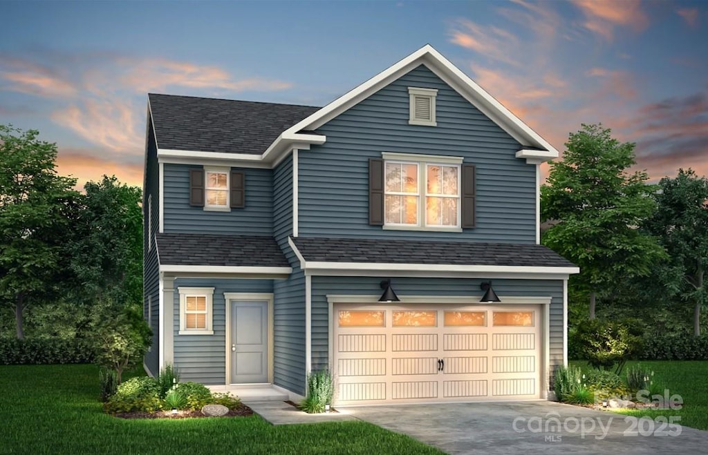 view of front property featuring a yard and a garage