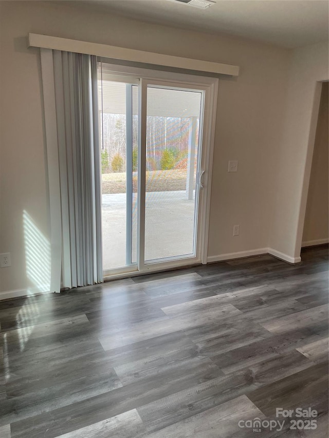 spare room with dark hardwood / wood-style flooring