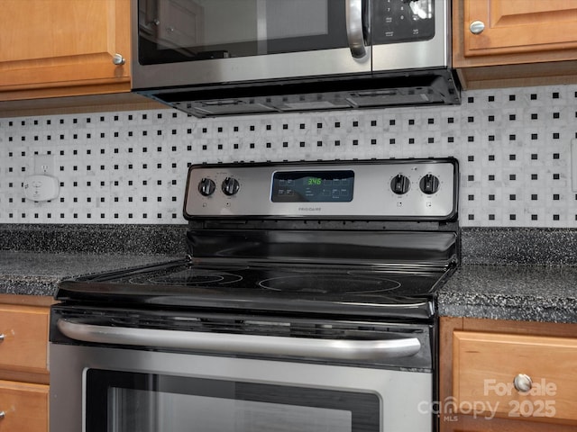 kitchen with tasteful backsplash and stainless steel appliances