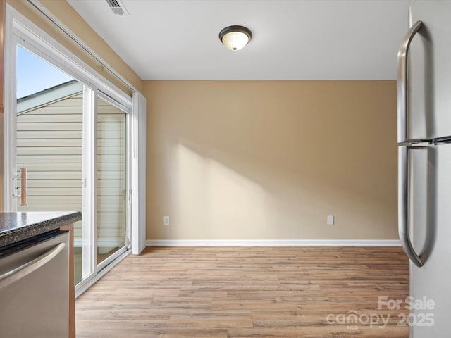 kitchen featuring plenty of natural light, stainless steel appliances, and light hardwood / wood-style floors