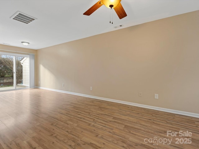 empty room featuring hardwood / wood-style flooring and ceiling fan