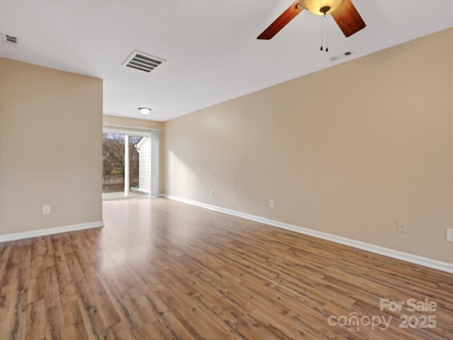 spare room with ceiling fan and wood-type flooring