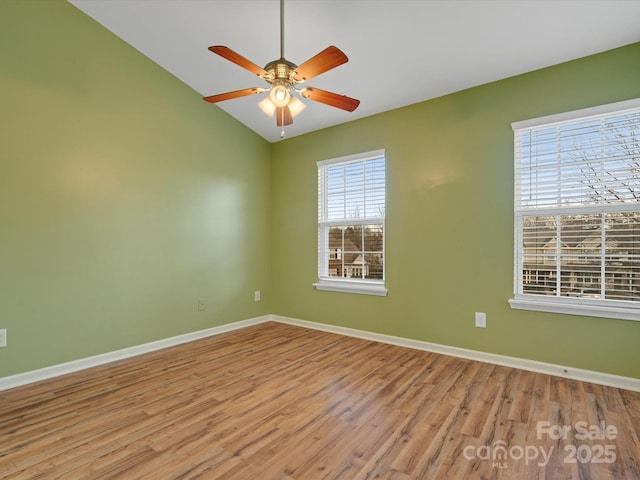 spare room featuring lofted ceiling, ceiling fan, and light hardwood / wood-style flooring