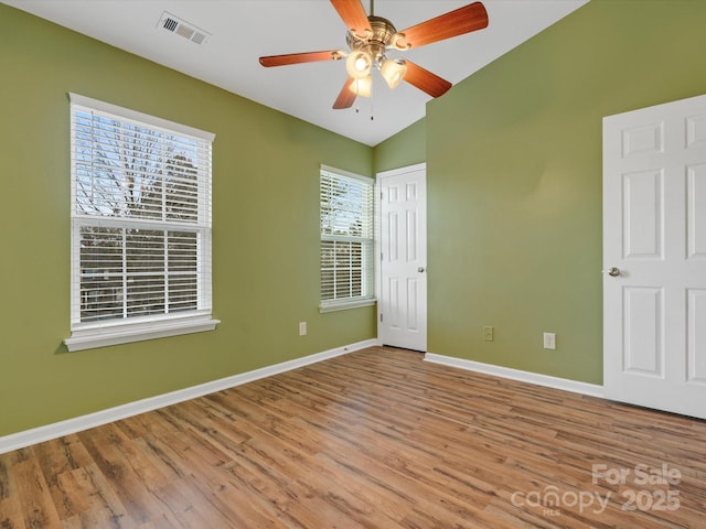 unfurnished bedroom featuring ceiling fan, vaulted ceiling, and light wood-type flooring