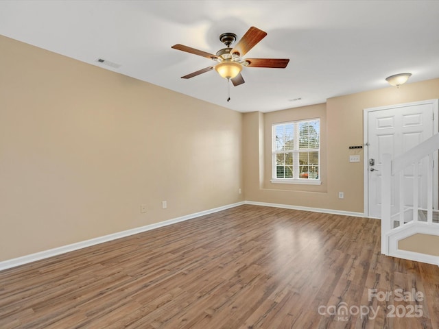 spare room with hardwood / wood-style flooring and ceiling fan