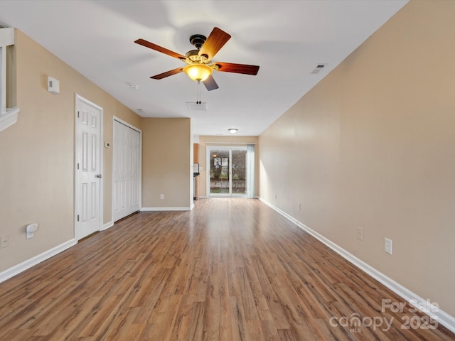 unfurnished living room featuring ceiling fan and light wood-type flooring