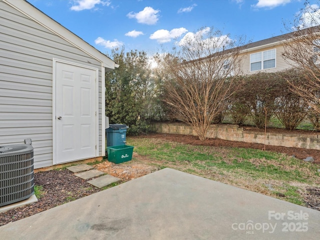 view of yard with central AC and a patio area