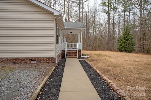 view of yard featuring covered porch