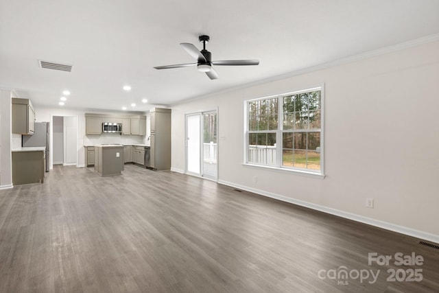 unfurnished living room featuring ornamental molding, dark hardwood / wood-style floors, and ceiling fan