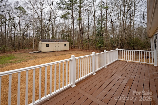 wooden terrace featuring a yard and a shed