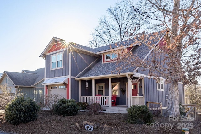 view of front of property with a porch and a garage