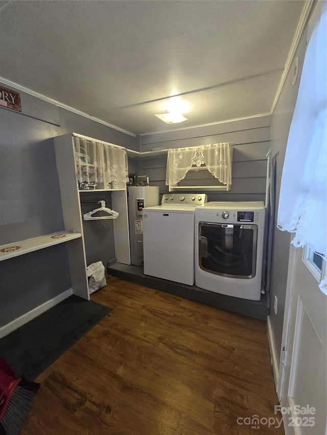 clothes washing area with dark hardwood / wood-style flooring, independent washer and dryer, and electric water heater