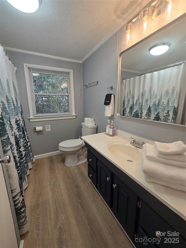 bathroom featuring hardwood / wood-style flooring, vanity, ornamental molding, a textured ceiling, and toilet