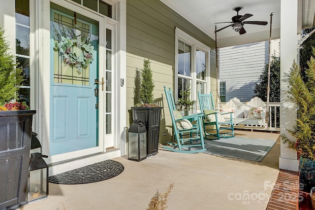 property entrance featuring ceiling fan and a porch