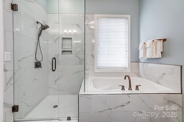 bathroom with a healthy amount of sunlight and shower with separate bathtub