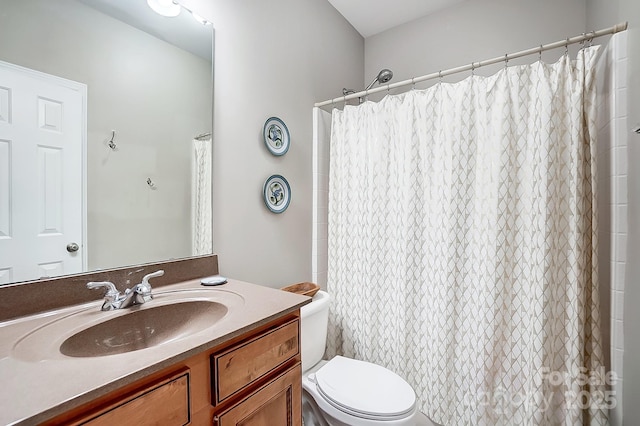 bathroom featuring vanity, toilet, and a shower with shower curtain