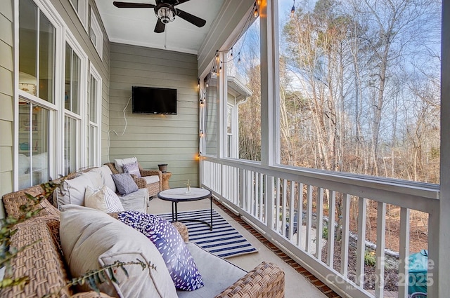 sunroom featuring ceiling fan and a healthy amount of sunlight