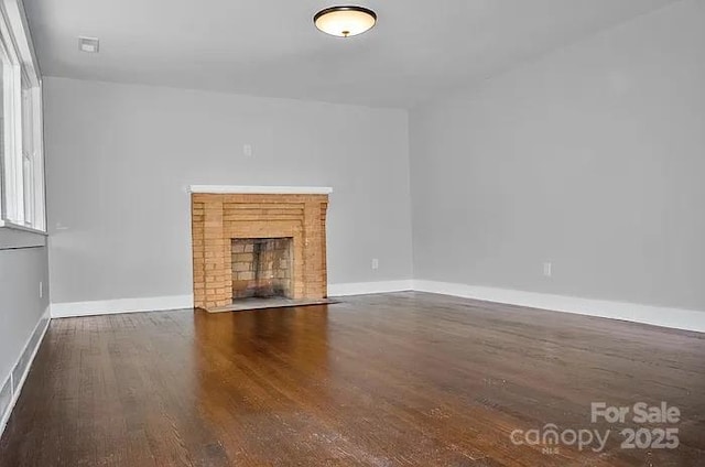 unfurnished living room with dark hardwood / wood-style flooring