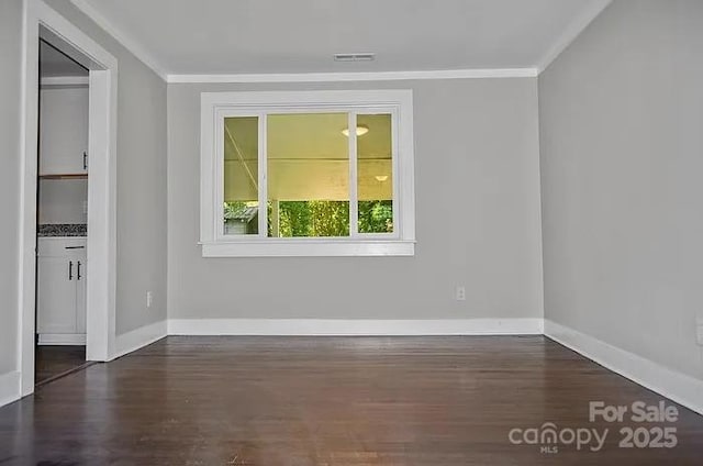 unfurnished room featuring dark hardwood / wood-style flooring and crown molding