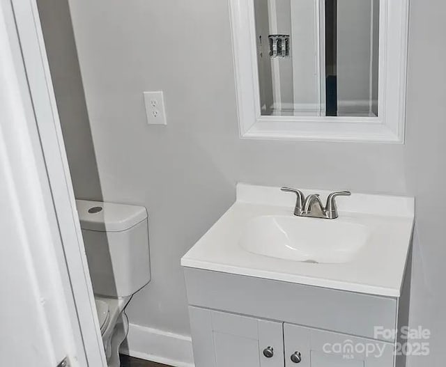 bathroom featuring vanity and toilet