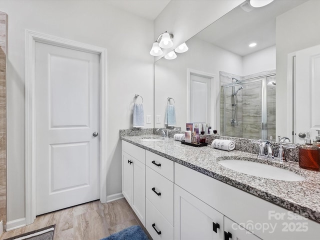 bathroom with vanity and a shower with shower door