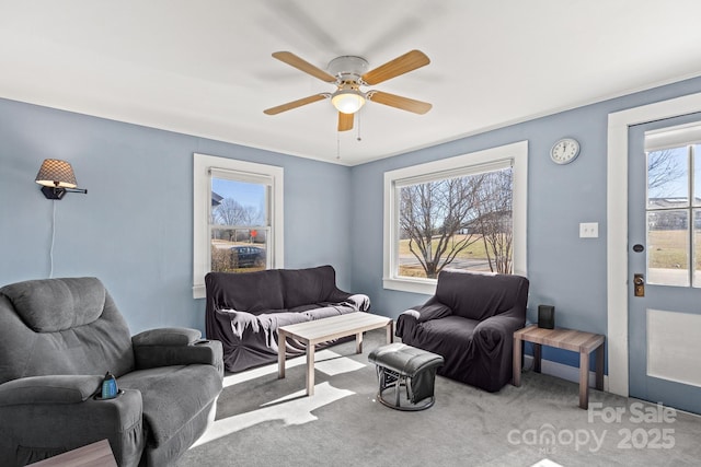 carpeted living room featuring ceiling fan