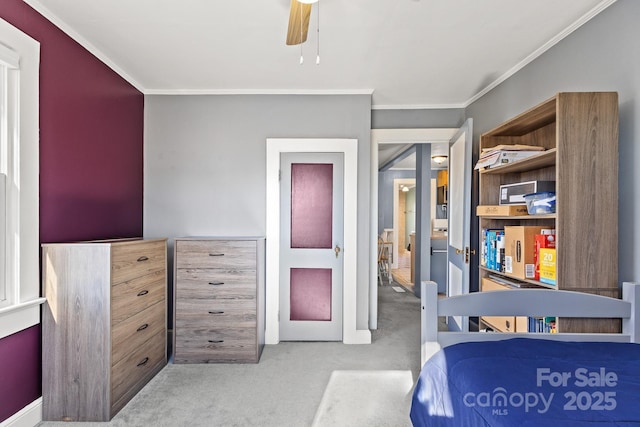 bedroom featuring ceiling fan, ornamental molding, and light carpet