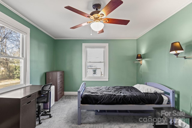 carpeted bedroom with crown molding and ceiling fan