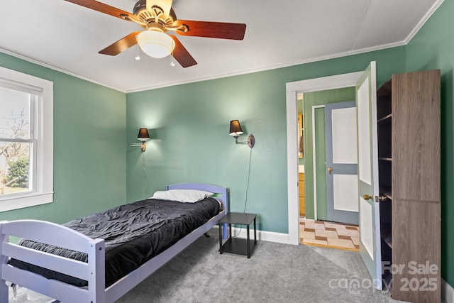 carpeted bedroom featuring ornamental molding and ceiling fan