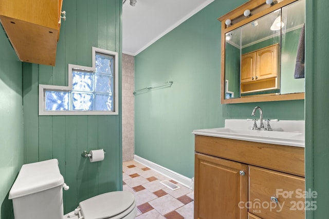 bathroom featuring vanity, crown molding, and toilet