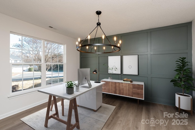 dining room featuring dark hardwood / wood-style flooring, a wealth of natural light, and a textured ceiling