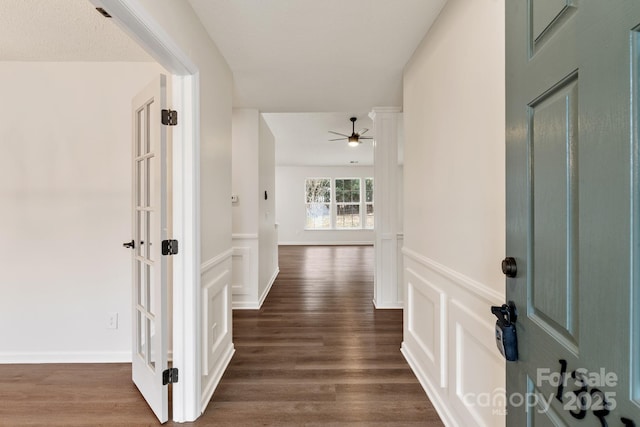 corridor featuring a textured ceiling and dark hardwood / wood-style flooring