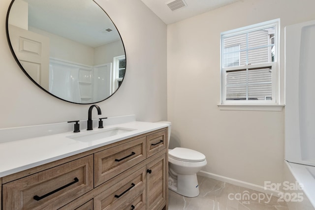 bathroom with vanity, tile patterned floors, and toilet