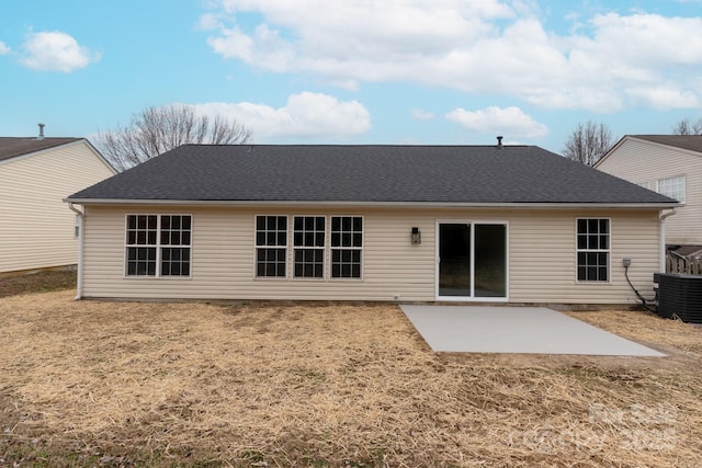 rear view of property featuring a patio, central AC, and a lawn