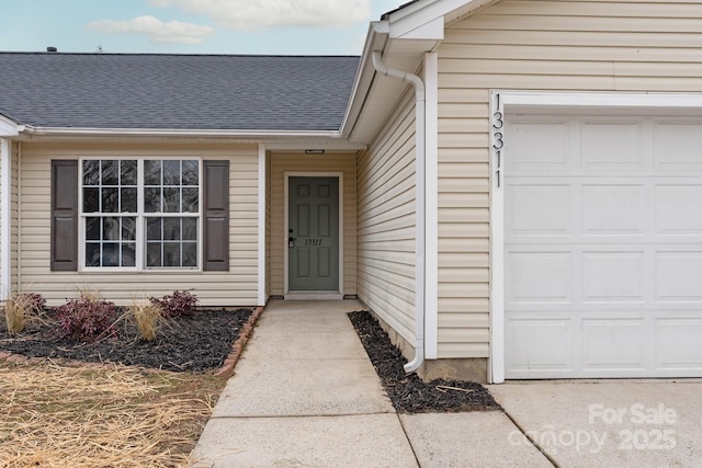 doorway to property with a garage