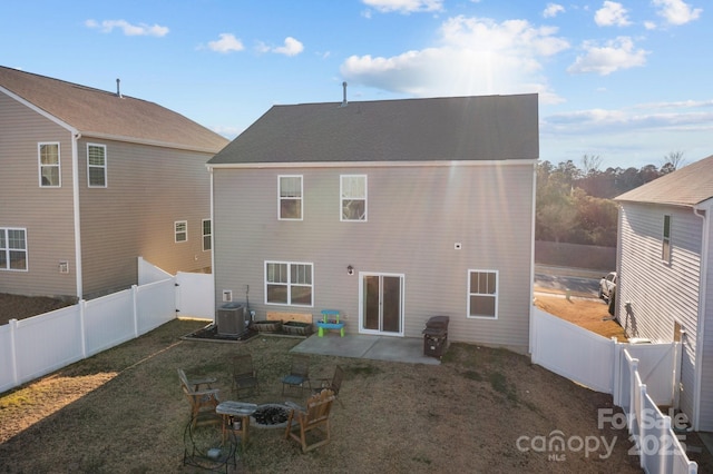 back of property with cooling unit, a yard, and a patio area