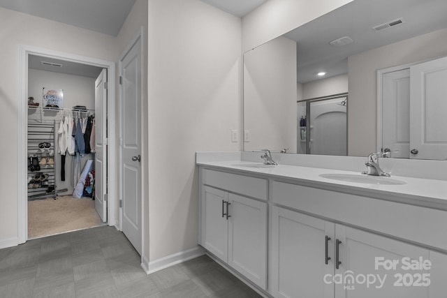 bathroom featuring vanity and a shower with door