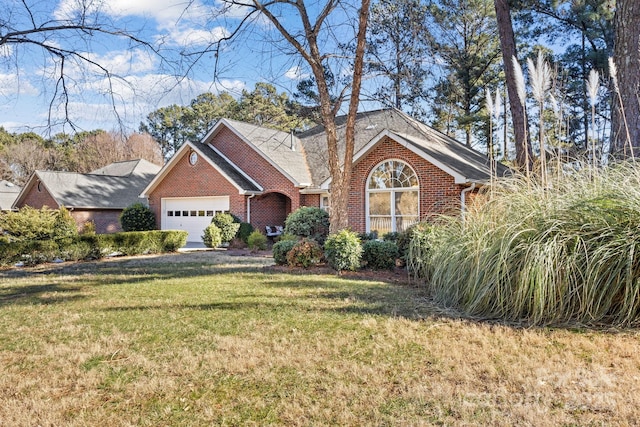 view of front of house with a garage and a front lawn