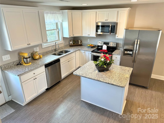 kitchen with white cabinetry, sink, hardwood / wood-style flooring, and stainless steel appliances