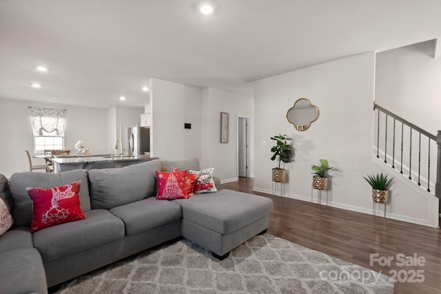 living room featuring sink and hardwood / wood-style floors