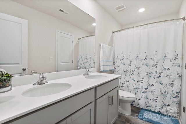 bathroom with vanity and toilet