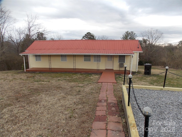 ranch-style house with a front lawn and covered porch