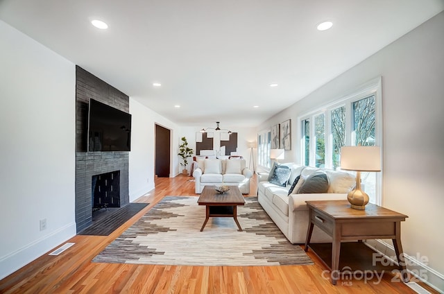 living room featuring a fireplace and hardwood / wood-style floors