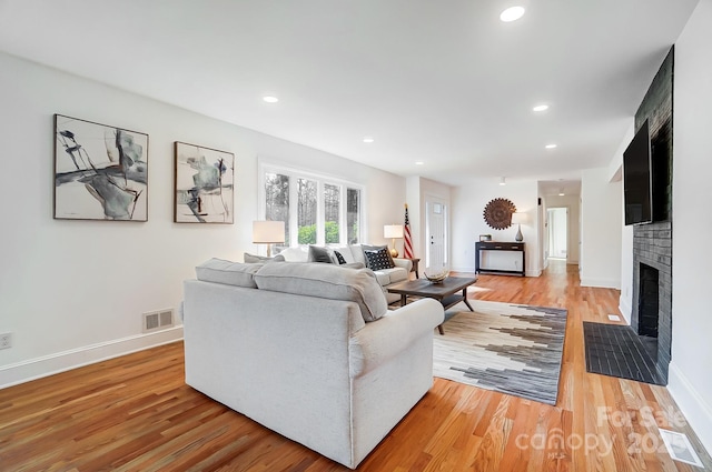 living room with a fireplace and light hardwood / wood-style floors