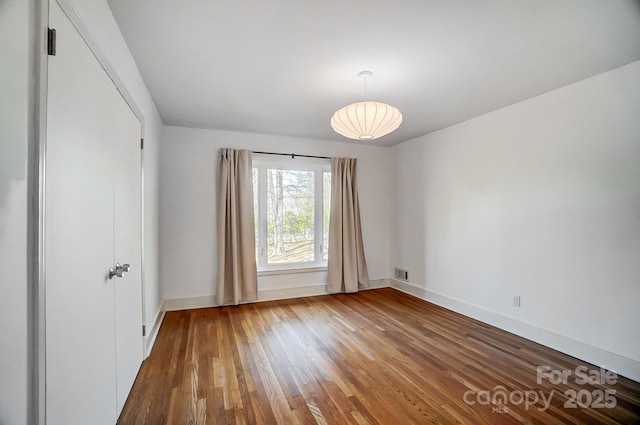 spare room with hardwood / wood-style flooring