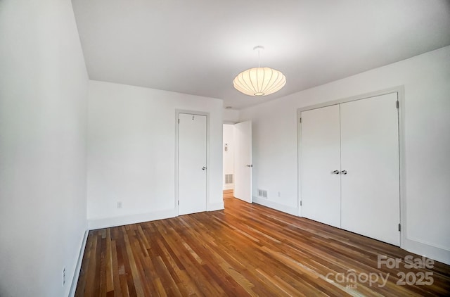 unfurnished bedroom featuring wood-type flooring