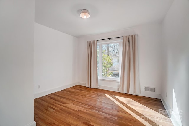 unfurnished room featuring light hardwood / wood-style floors