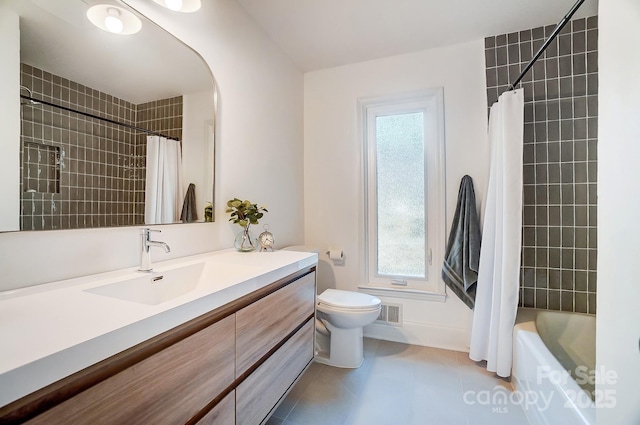 full bathroom featuring vanity, toilet, tile patterned flooring, and shower / bath combo with shower curtain