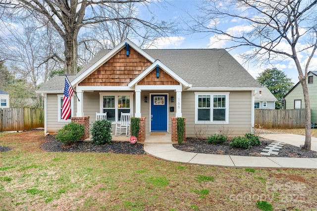 view of front of home featuring covered porch and a front yard