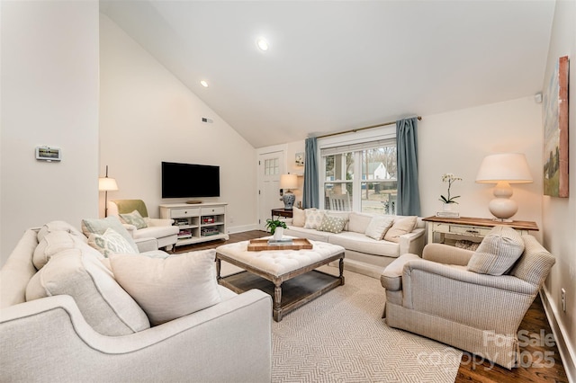 living room featuring wood-type flooring and high vaulted ceiling